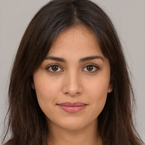 Joyful white young-adult female with long  brown hair and brown eyes