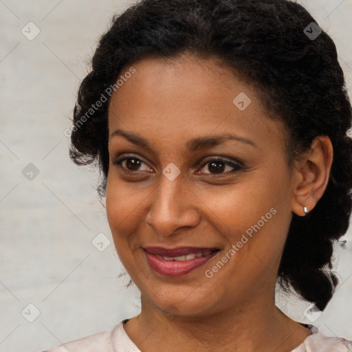 Joyful black young-adult female with medium  brown hair and brown eyes