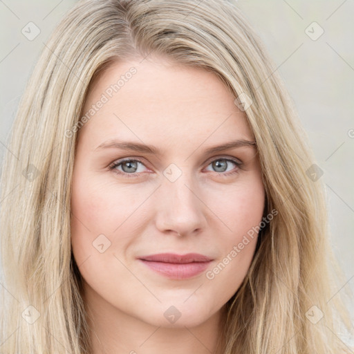 Joyful white young-adult female with long  brown hair and blue eyes