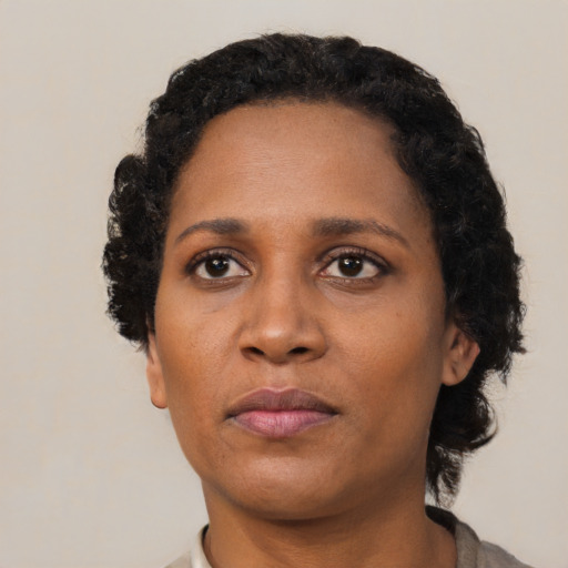 Neutral black adult female with short  black hair and brown eyes