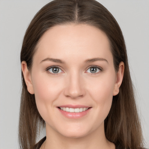 Joyful white young-adult female with long  brown hair and grey eyes