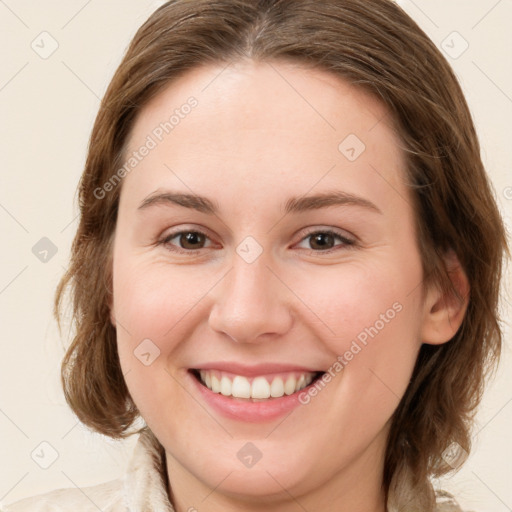 Joyful white young-adult female with medium  brown hair and green eyes