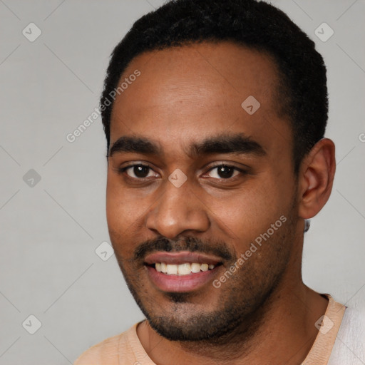 Joyful black young-adult male with short  black hair and brown eyes