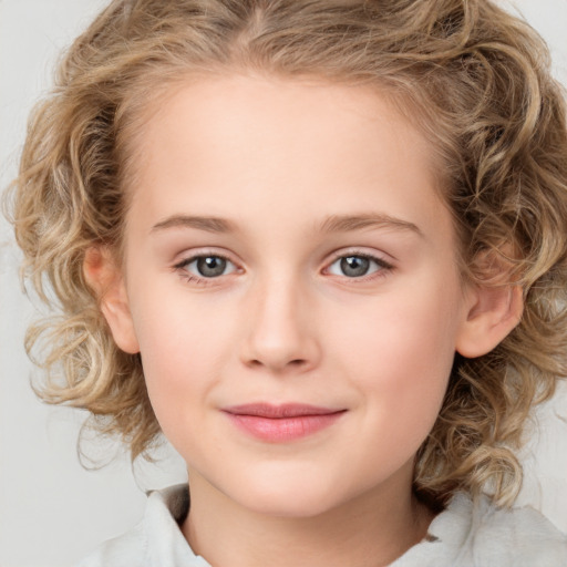 Joyful white child female with medium  brown hair and grey eyes