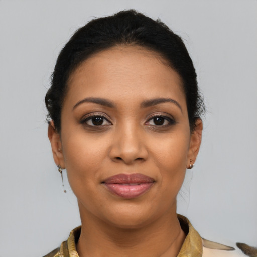 Joyful latino young-adult female with medium  brown hair and brown eyes