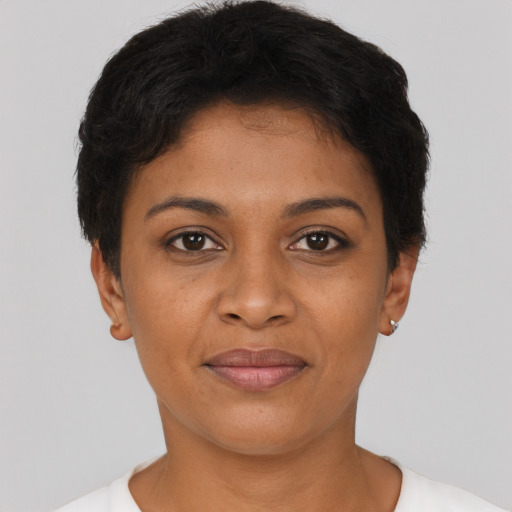 Joyful black young-adult female with short  brown hair and brown eyes