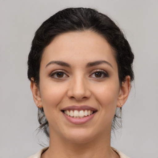 Joyful latino young-adult female with medium  brown hair and brown eyes