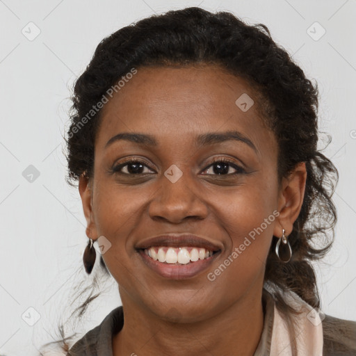 Joyful black young-adult female with long  brown hair and brown eyes