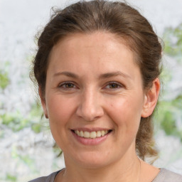 Joyful white adult female with medium  brown hair and brown eyes