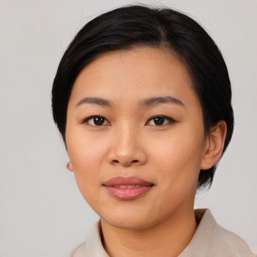 Joyful asian young-adult female with medium  black hair and brown eyes