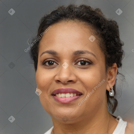 Joyful black adult female with short  brown hair and brown eyes