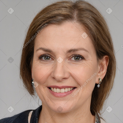 Joyful white adult female with medium  brown hair and grey eyes