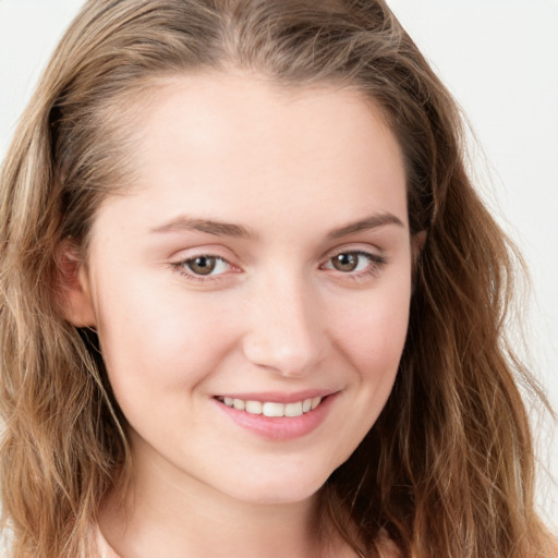 Joyful white young-adult female with long  brown hair and blue eyes