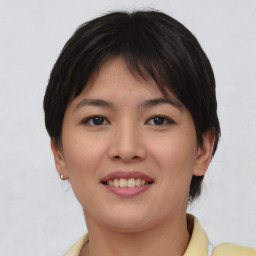 Joyful asian young-adult female with short  brown hair and brown eyes