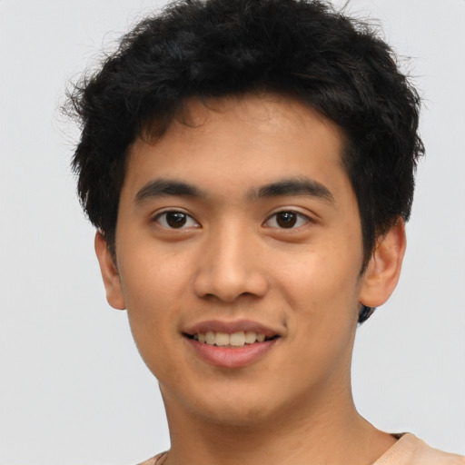 Joyful asian young-adult male with short  black hair and brown eyes