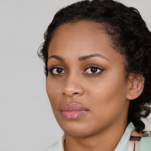 Neutral black young-adult female with medium  brown hair and brown eyes