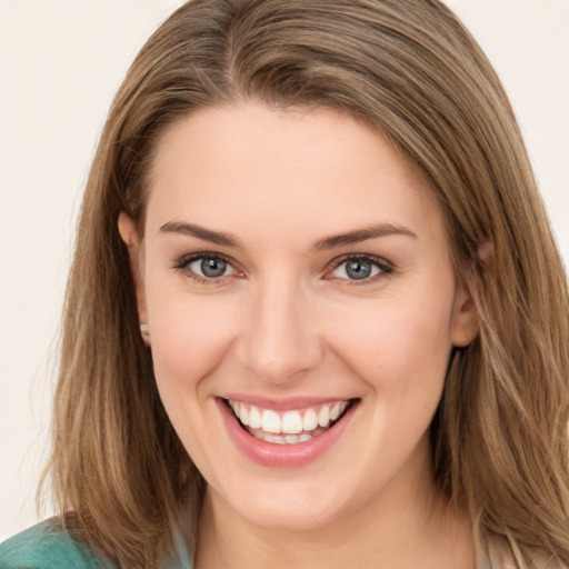 Joyful white young-adult female with long  brown hair and green eyes