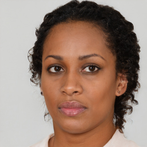 Neutral black young-adult female with medium  brown hair and brown eyes