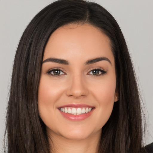 Joyful white young-adult female with long  brown hair and brown eyes