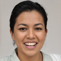 Joyful latino young-adult female with medium  brown hair and brown eyes