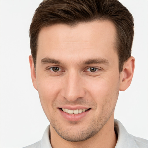 Joyful white young-adult male with short  brown hair and grey eyes