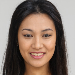 Joyful asian young-adult female with long  brown hair and brown eyes