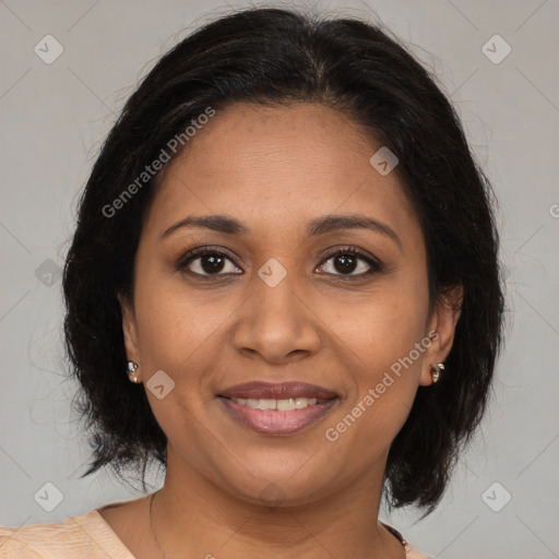 Joyful black adult female with medium  brown hair and brown eyes