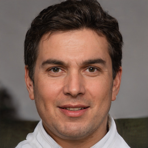 Joyful white adult male with short  brown hair and brown eyes