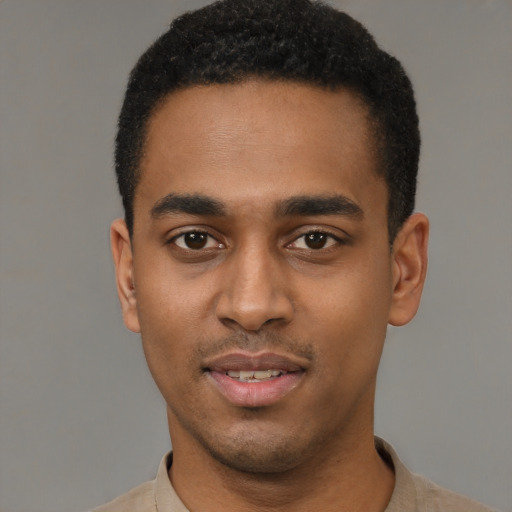 Joyful black young-adult male with short  black hair and brown eyes