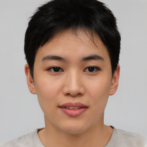 Joyful asian young-adult female with short  black hair and brown eyes