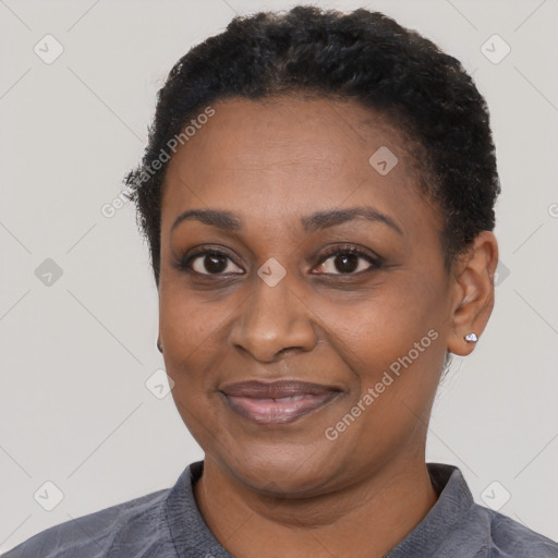 Joyful black adult female with short  black hair and brown eyes