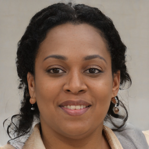 Joyful black young-adult female with medium  brown hair and brown eyes