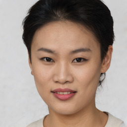 Joyful asian young-adult female with short  brown hair and brown eyes