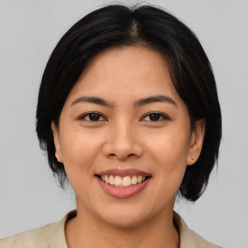 Joyful asian young-adult female with medium  black hair and brown eyes