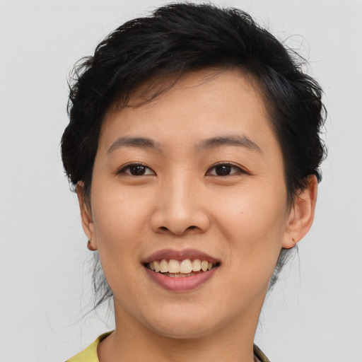 Joyful asian young-adult female with short  black hair and brown eyes