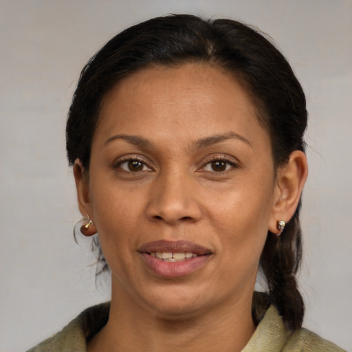Joyful black young-adult female with medium  brown hair and brown eyes