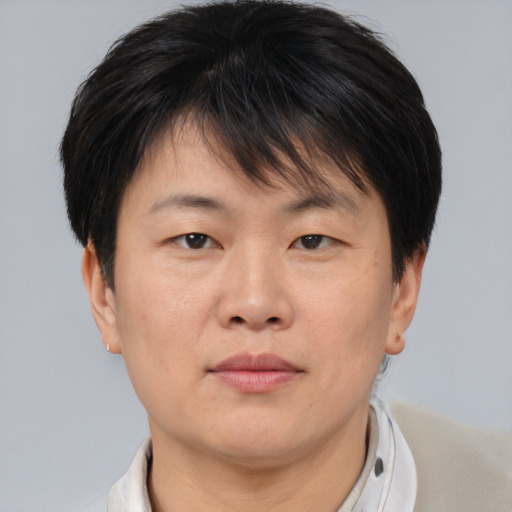 Neutral asian adult male with short  brown hair and brown eyes
