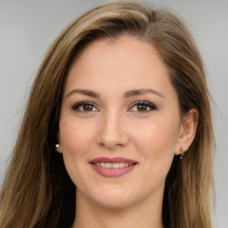 Joyful white young-adult female with long  brown hair and brown eyes