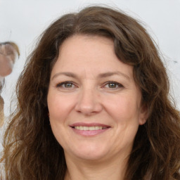 Joyful white adult female with long  brown hair and brown eyes