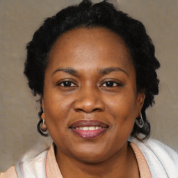 Joyful black adult female with medium  brown hair and brown eyes