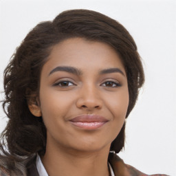 Joyful black young-adult female with long  brown hair and brown eyes