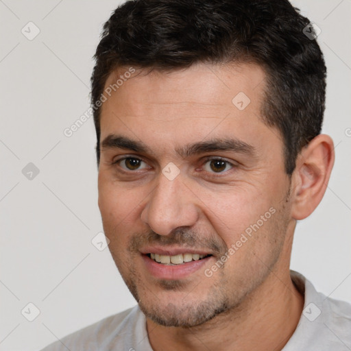 Joyful white adult male with short  brown hair and brown eyes