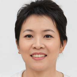 Joyful asian young-adult female with short  brown hair and brown eyes