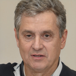 Joyful white middle-aged male with short  brown hair and brown eyes