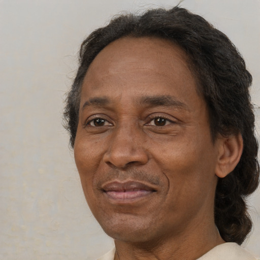 Joyful black adult male with short  brown hair and brown eyes
