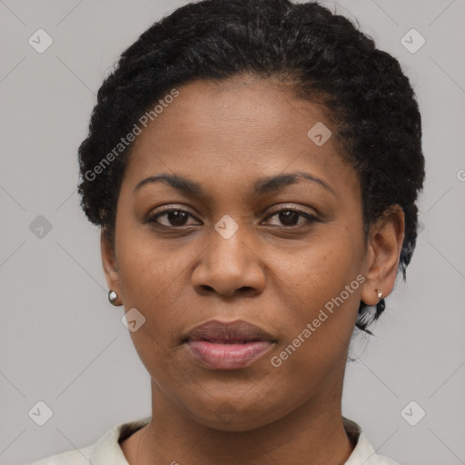 Joyful black young-adult female with short  black hair and brown eyes