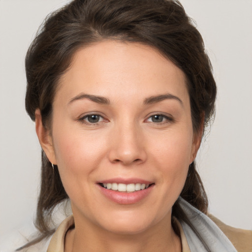 Joyful white young-adult female with medium  brown hair and brown eyes