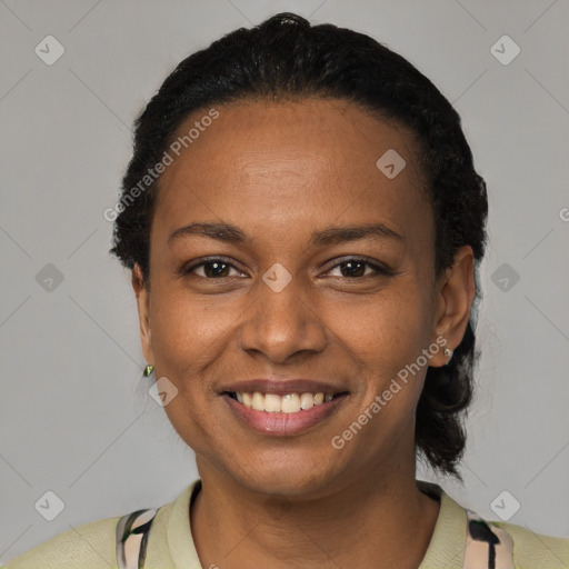 Joyful black young-adult female with short  black hair and brown eyes