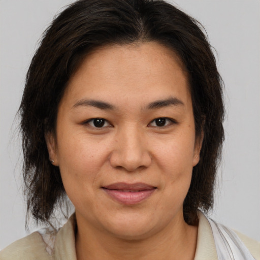 Joyful white adult female with medium  brown hair and brown eyes