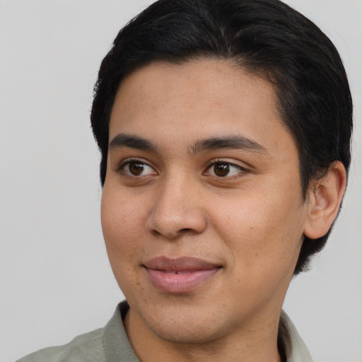 Joyful latino young-adult male with short  brown hair and brown eyes
